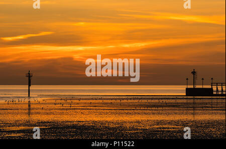 Beautiful red and orange sky by the sea at dusk after the sun has set, on the South Coast in West Sussex, England, UK. Stock Photo