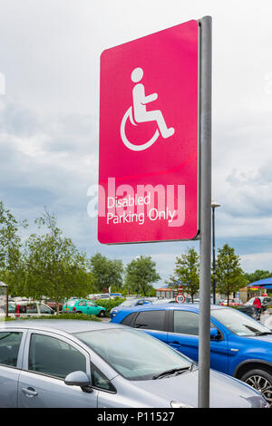 Disabled Parking Only sign in a shopping centre car park in England, UK. Disabled parking spaces.