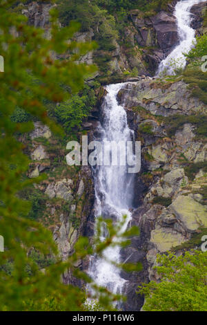 Small cute hidden waterfall absorbed in wild mountain nature Stock Photo
