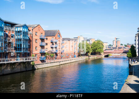 Buildings along the River Aire with Crown Point Bridge in the distance, Leeds, West Yorkshire, England, UK Stock Photo