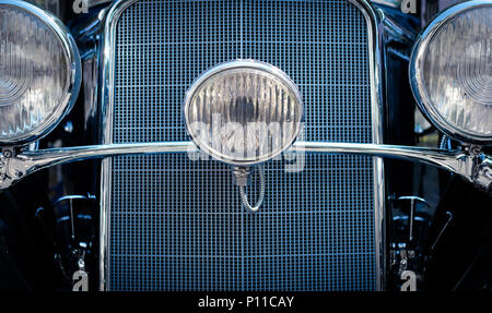 Oldtimer concept -  front headlight and grill detail of vintage car - Stock Photo
