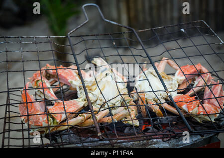 Giant crab beeing grilled on simple coal fire barbecue at Tokeh Beach, Sierra Leone, Africa Stock Photo