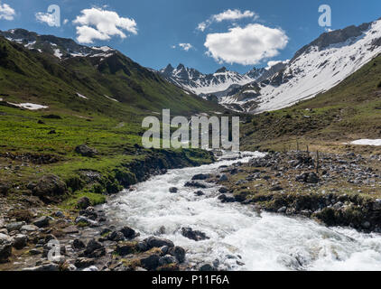beautiful mountain valley near Klosters on a summer day with a small creek running through it Stock Photo