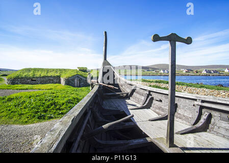 Reconstruction of Norse Viking longhouse and the Skidbladner, full size replica of Gokstad ship at Brookpoint, Unst, Shetland Islands, Scotland, UK Stock Photo