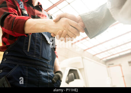 Mechanic And Client Shaking Hands Stock Photo