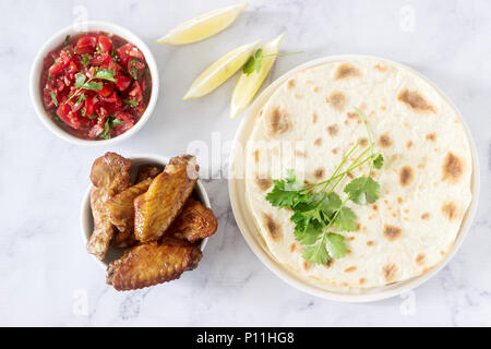 Homemade delicious food of tortillas, salsa and fried wings. Selective focus. Stock Photo