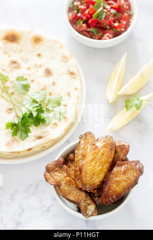 Homemade delicious food of tortillas, salsa and fried wings. Selective focus. Stock Photo