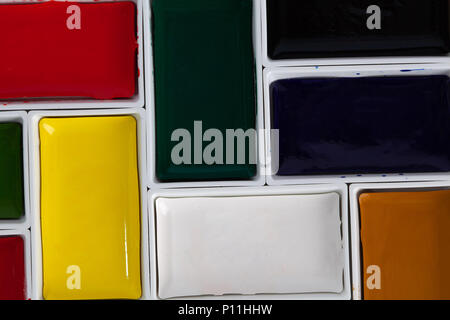 Solid watercolor pans arranged in jigsaw puzzle top view with copy space Stock Photo
