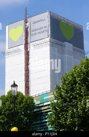 Grenfell Tower where at least 72 people died after a fire broke out on June 14th 2017 in North Kensington with the slogan 'Forever in our Hearts'. Stock Photo