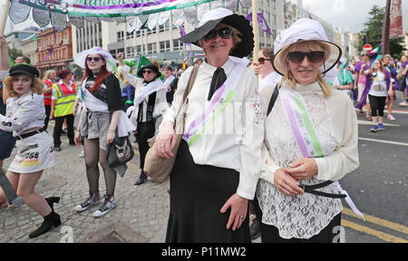 Women dressed as suffragettes take part in the Processions' artwork march, in Belfast, as they mark 100 years since the Representation of the People Act which gave the first British women the right to vote and stand for public office. Stock Photo