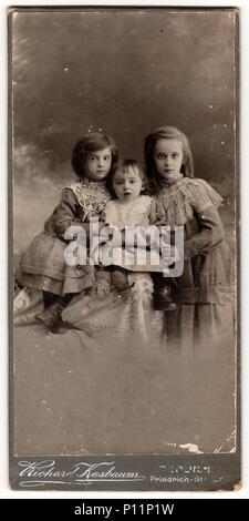 BERLIN, GERMANY- CIRCA 1905: A vintage cabinet card shows cute children girls . Antique black white photo. Stock Photo