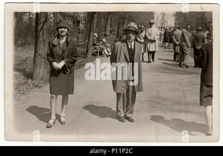 PREROV, THE CZECHOSLOVAK REPUBLIC - APRIL 26, 1928: Vintage photo shows young man and woman pose in the city park. Stock Photo