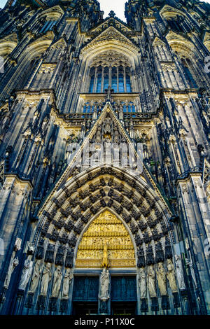 The center main portal of Cologne cathedral is the only one, which has not a special name. It is 9.3 metres wide and, including its gable, more than 28 metres high. The theme of the centre portal is the age before redemption. The trumeau figure in the main portal is Mary, the link between the Old and New Testaments. She is flanked by Peter, the saint to whom the cathedral is dedicated, and the Magi, whose precious relics are venerated in the cathedral. Stock Photo