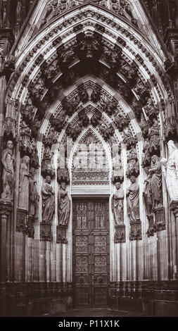 The North portal of the West facade at Cologne Cathedral is also called ‚Portal of the Three Kings’ or ‚Magi portal‘. The tympanum above the door shows in the lower section the Three Kings before Herod and in the upper part The Adoration of the Magi. Stock Photo
