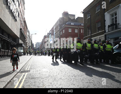 Police observing pro-Palestinian demonstrators outside the Embassy of Saudi Arabia, London, during an Al-Quds Day march in support of Palestinians. Stock Photo