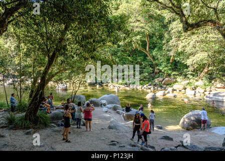 Tourists looking at and swimming in the Mossman River in the Mossman Gorge in Far North Queensland Stock Photo