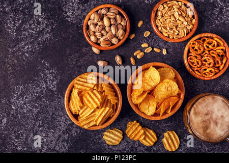 Beer with snacks on stone background. Top view, copy space. Stock Photo