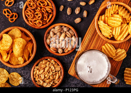 Beer with snacks on stone background. Top view, copy space. Stock Photo