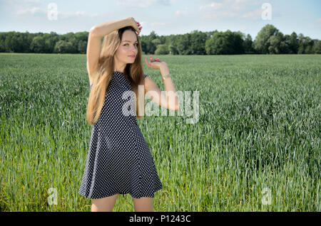 Petite woman walking in the grain field, wearing white dress. Female model  and nature Stock Photo - Alamy