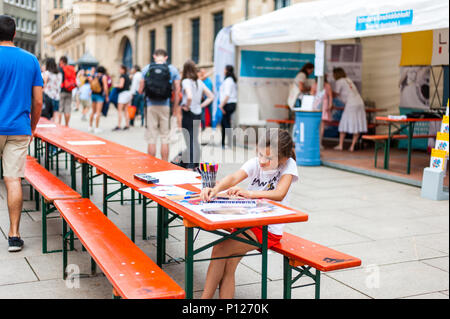 Small girl enjoying painting with felt tip pens in a drawing book, Luxembourg Stock Photo