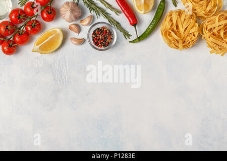 Italian food background with pasta, spices and vegetables. Top view, copy space. Stock Photo