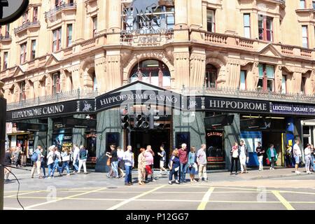 Hippodrome Casino, Leicester Square, London, UK showing people walking around in the sunshine.  Theatre and tourism area. Stock Photo