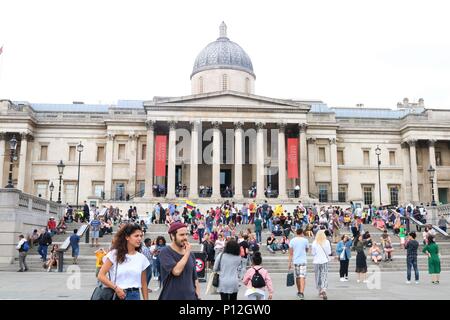 People enjoying the sunny weather at Trafalgar Square, London, UK Stock Photo