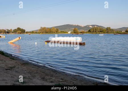 PASOHLAVKY, CZECH REPUBLIC - JUNE 03, 2017: Obstacles in water in the wake park Merkur in South Moravia at sunset, with Palava mountains in the backgr Stock Photo