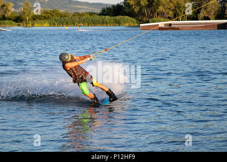 PASOHLAVKY, CZECH REPUBLIC - JUNE 03, 2017: Rider wakeboarding in the cable wake park Merkur in the Palava region in South Moravia Stock Photo