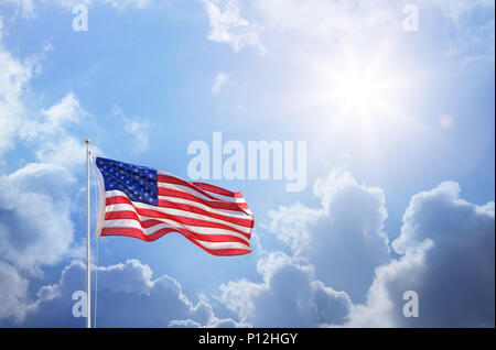 American Flag Against Blue Sky Stock Photo