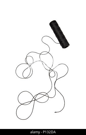 Spool of black string on white background Stock Photo