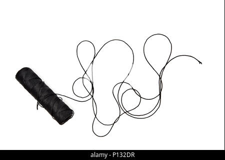 Spool of black string on white background Stock Photo