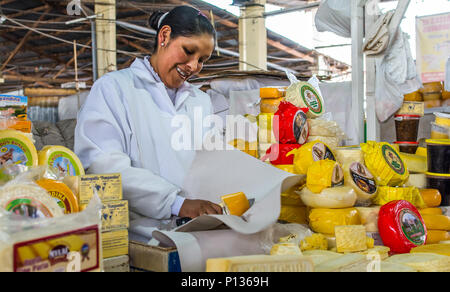 Local Peruvian woman cheese vendor in Mercado Central de San Pedro, San Pedro Market, in Cusco, Cuzco. Peru South America. Stock Photo