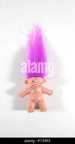 NEW YORK, NY - APRIL 29, 2016: Little mini troll doll with bright purple hair Stock Photo