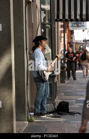 A street musician plays electric guitar and sings in the French Quarter of New Orleans, Louisiana. Stock Photo