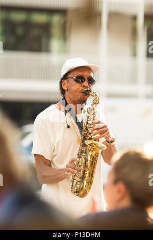 A saxophone playing street musician on Canal Street in New Orleans, Louisiana. Stock Photo