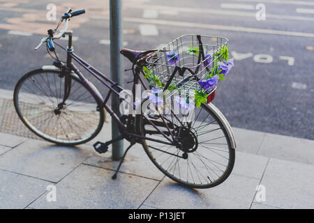 DUBLIN, IRELAND - May 23rd, 2018: bike with flower decoration parked in Dublin city centre Stock Photo