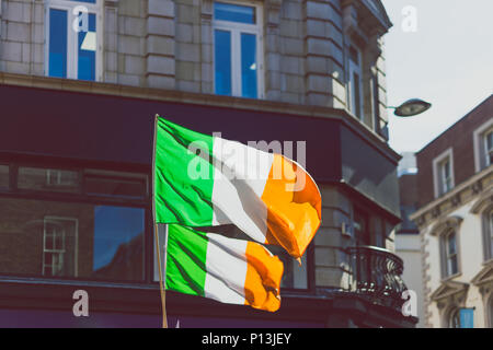 DUBLIN, IRELAND - May 23rd, 2018: Irish flags waving off of building in Grafton street Stock Photo