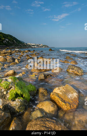 a beautiful and atmospheric seascape of the rocky foreshore, beach and cliffs at the breathtaking Steephill cove, Ventnor, Isle of Wight, UK. Stock Photo