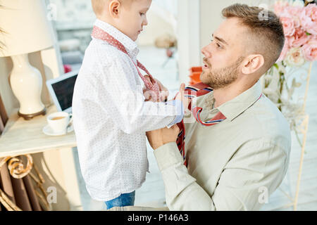 Knotting Neckties with Little Son Stock Photo