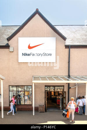 Shoppers outside the Nike Factory Store in Gretna Gateway Outlet Village a strip mall in the very south of Scotland Stock Photo Alamy