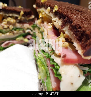 Giant deli cold cut sandwich on pumpernickel bread Stock Photo