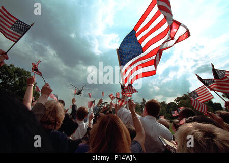 Staff members wave American flags as they gather on the South Lawn of the White House Friday, Sept. 21, 2001, as President George W. Bush and Mrs. Laura Bush depart for Camp David aboard Marine One. Stock Photo