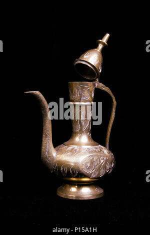 A brass pitcher or container in studio Stock Photo