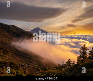 The spectacle of the setting sun in the clouds.Sunset in the Teide volcano national park. Stock Photo