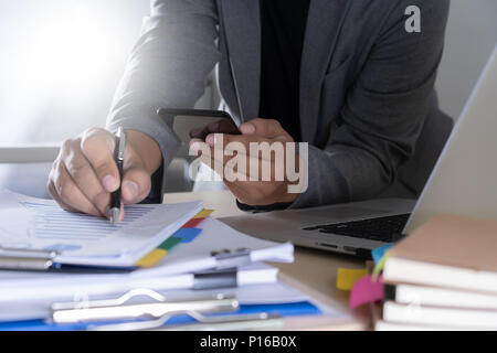 businessman using phone smart phone and notebook computer Stock Photo