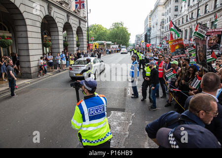 London, UK. 10th June, 2018. A police officer films members of a far-right group taunting hundreds of people taking part in the pro-Palestinian Al Quds Day march through central London organised by the Islamic Human Rights Commission. An international event, it began in Iran in 1979. Quds is the Arabic name for Jerusalem. Credit: Mark Kerrison/Alamy Live News Stock Photo