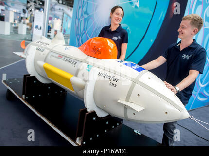 Hannover, Germany. 11th June, 2018. Sarah Wieners and Christopher Wetzel, both research assistant of the Fraunhofer Society stand next to an autonomous underwater vehicle that is able to map the sea ground at the stand of the Fraunhofer Society at the digital fair 'Cebit'. Cebit is attempting a new 'festival' format after three decades, taking place between the 11th and the 15th of June. Photo: Hauke-Christian Dittrich/dpa Credit: dpa picture alliance/Alamy Live News Stock Photo