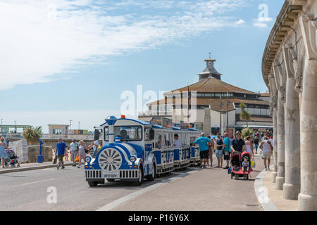 Bournemouth, UK. 11th June 2018. Tourists queue for the land train on Bournemouth beach and seafront. Credit: Thomas Faull/Alamy Live News Stock Photo