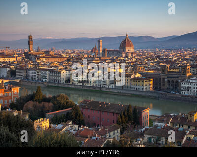 Florence, Italy - March 24, 2018: Morning light illuminates the cityscape of Florence, including the historic landmarks of Palazzo Vecchio and the Duo